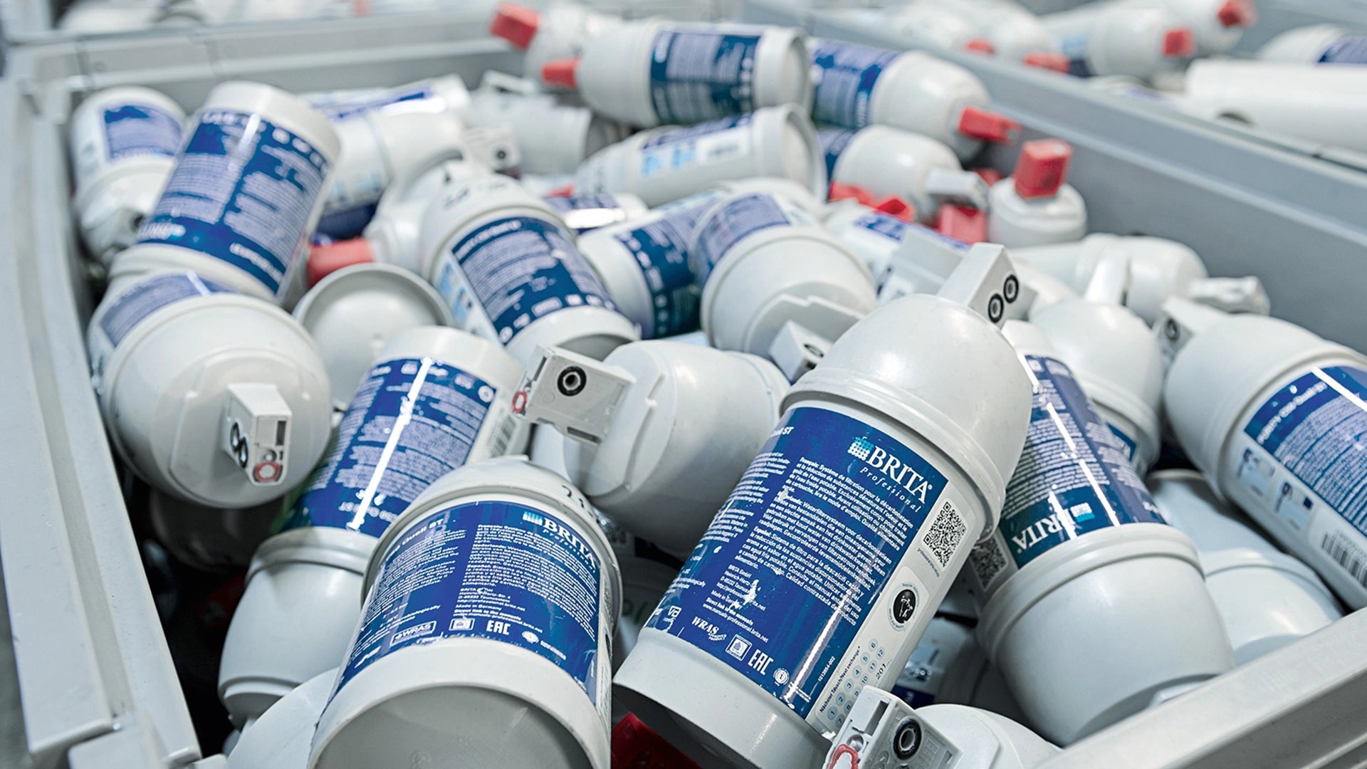 Collection of BRITA professional filter cartridges with blue labels.