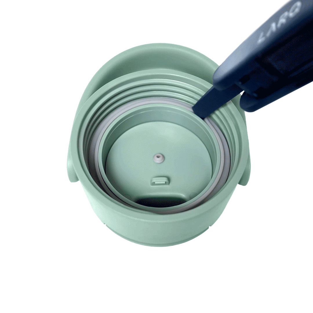 Close-up of a BRITA LARQ Cleaning Brush removing the O-ring from a BRITA LARQ Bottle lid