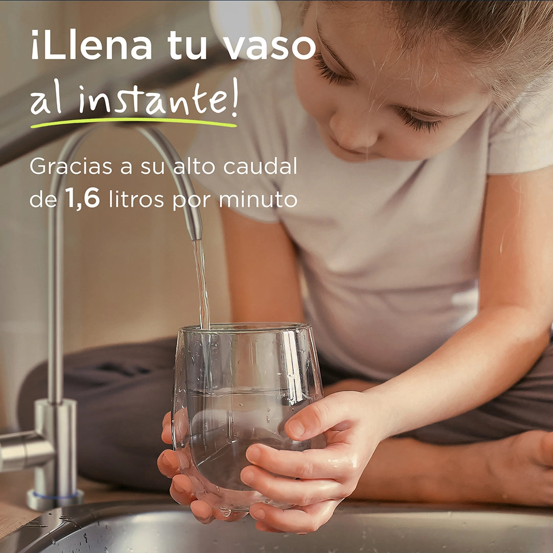 Child filling a drinking glass with filtered water from a kitchen tap