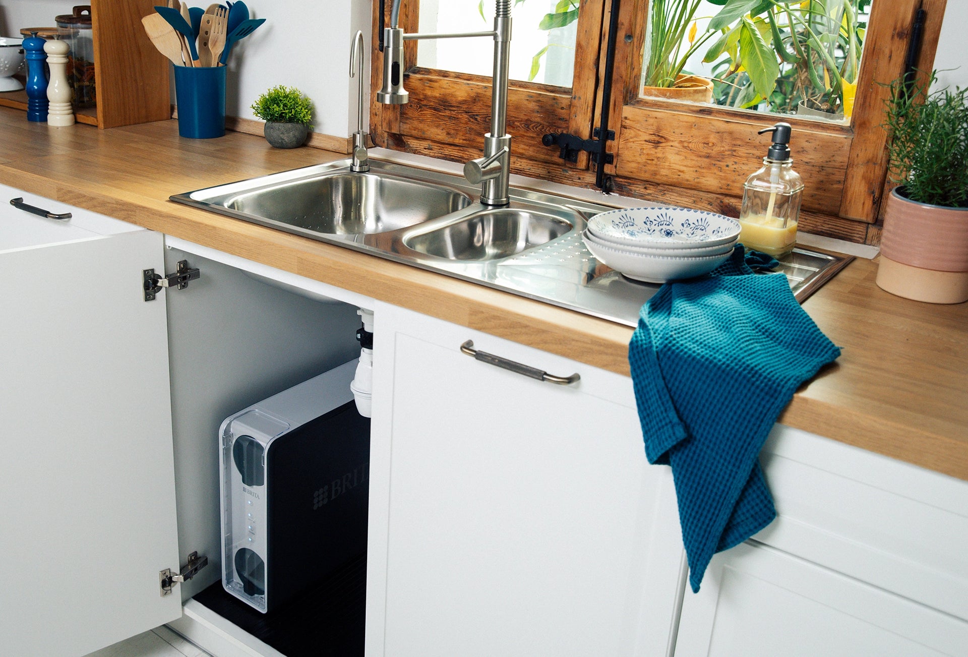 BRITA mypure RO water filtration system installed in a kitchen cabinet beneath the sink.