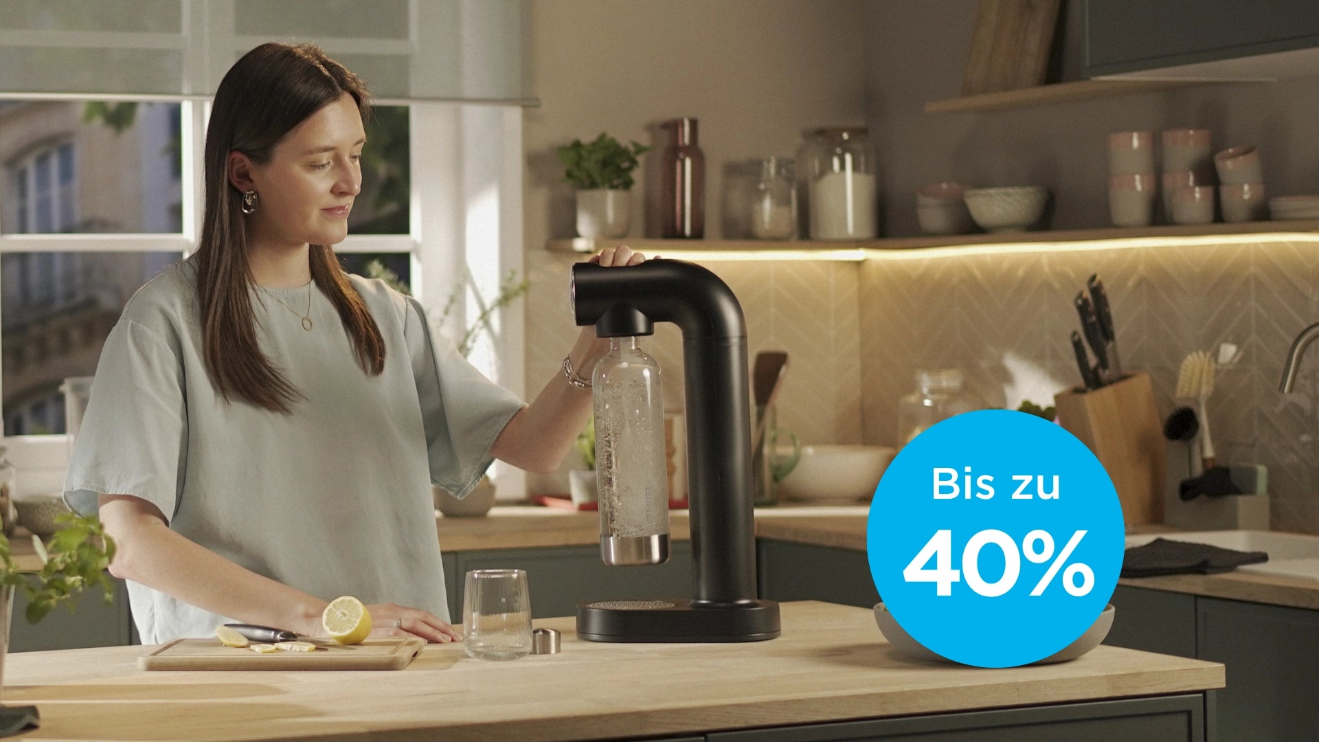 Woman using a  BRITA sodaONE sparkler with a discount label in the corner.
