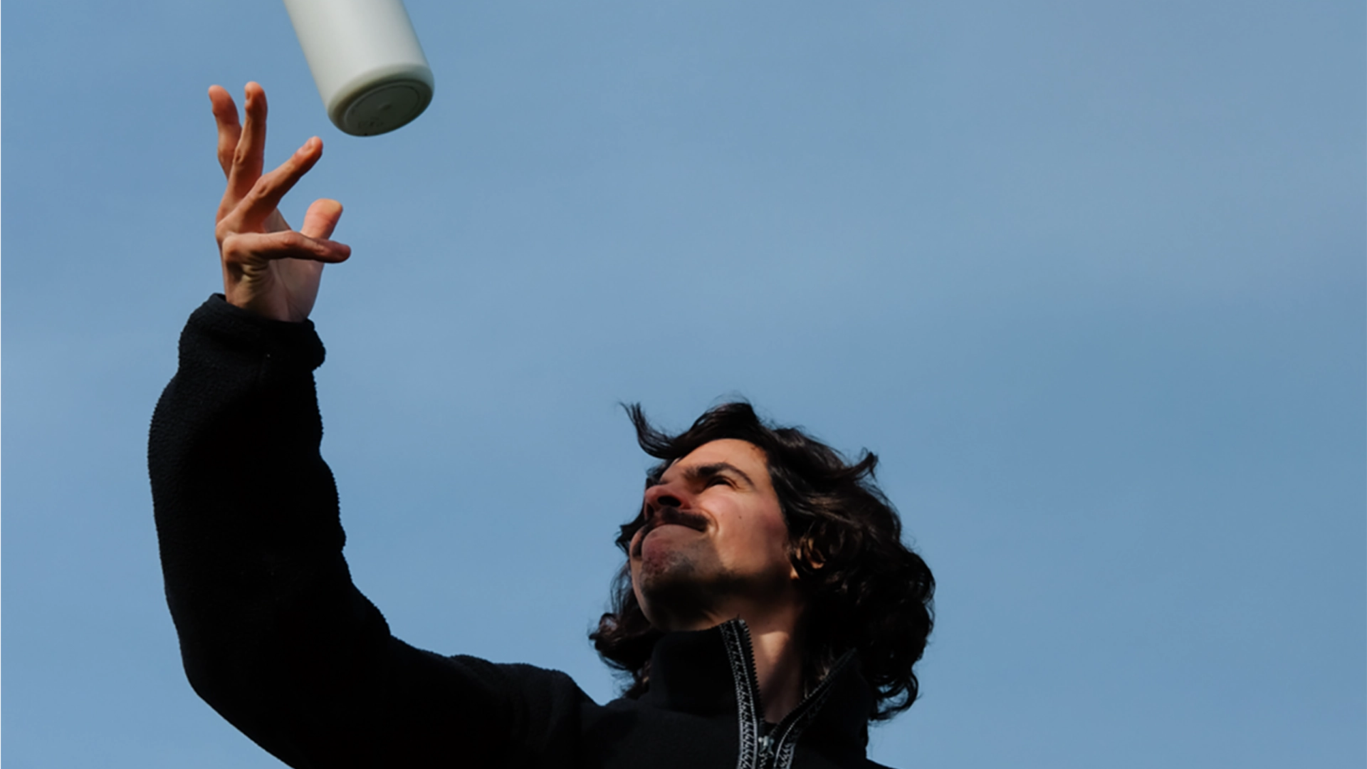 Man throwing a white BRITA LARQ Bottle.