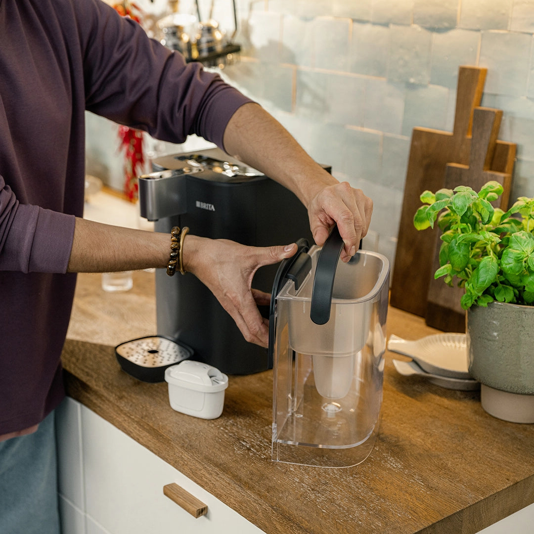 BRITA YOURCE cool water dispenser with removable water tank being lifted from the appliance